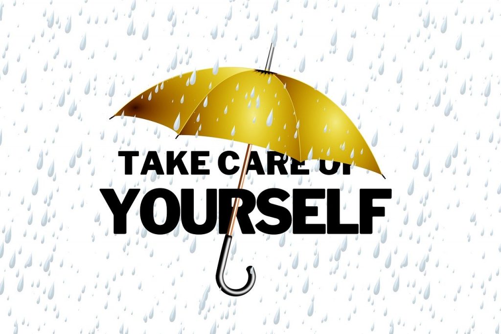 Gold Umbrella Over Black Text That Says Take Care of Yourself with Rain Falling